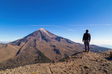 A beautiful shot of a male standing in Pico de Orizaba Volcano in Mexico