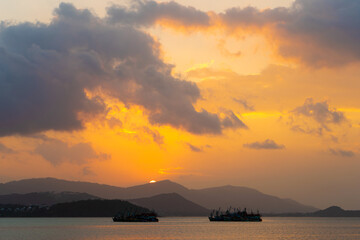 Fototapeta na wymiar Sunset over the bay with fishing boats