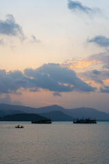 Naklejka na ściany i meble Sunset over the bay with fishing boats
