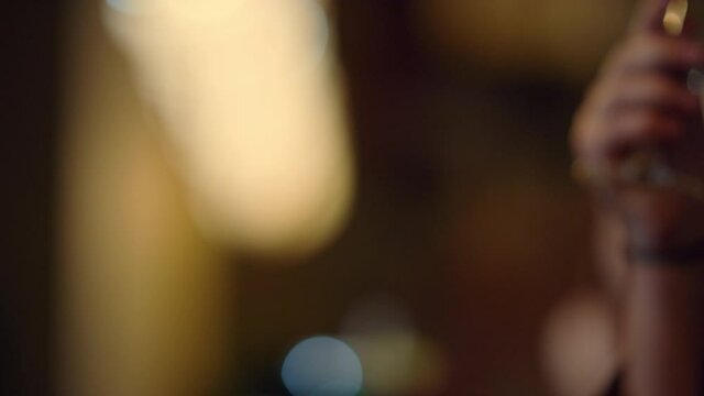 People hands clinking glasses indoors. Group of friends toasting inside.