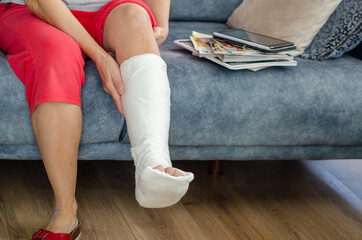 The middle aged woman with broken leg at home