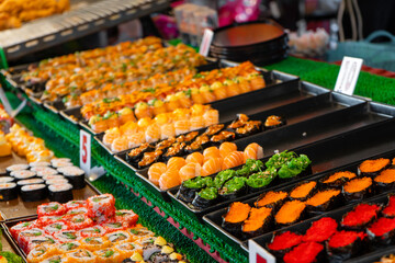 Night food market in asia. Outdoor sushi counters.