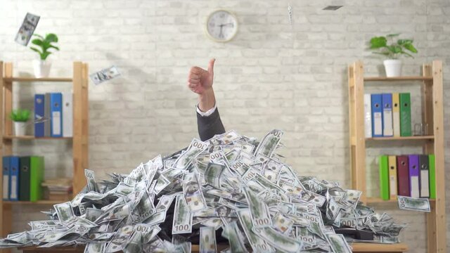 Thumbs up and piles of money on the table flying banknotes, slow mo