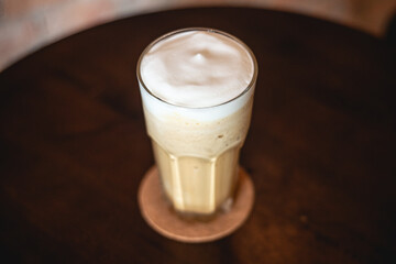 Milk tea on brown desk. Beverage for summer.