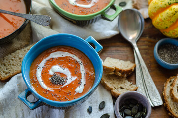 Pumpkin soup served  in bowl on the table