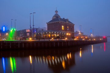 Medieval traditional building in the city Harlingen in the Netherlands at sunset