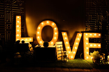 Design of the letters love glowing light bulb letters. concept of love, relationship, valentine's...
