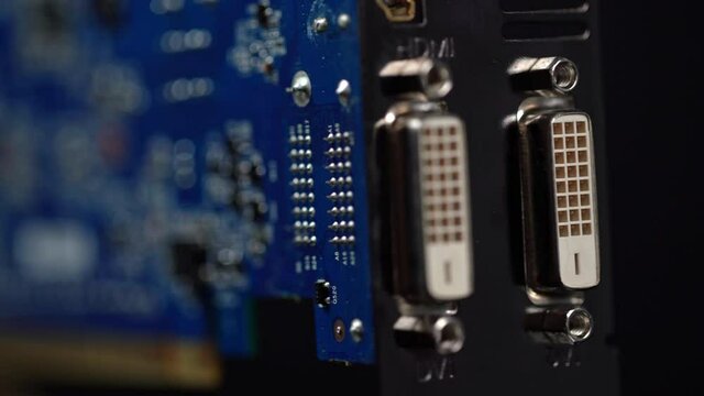 Graphics card for PS platform with two dvi ports, component for video games and cryptocurrency minerization. On a black background in motion.