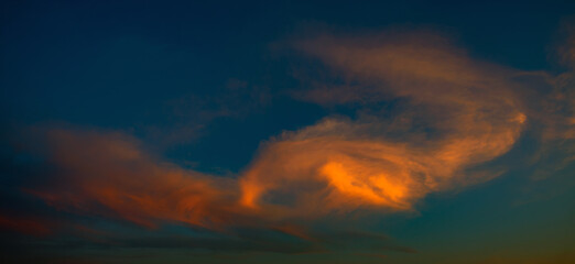 Dramatic sky at sunset with blue sky   yellow and orange cloud colors.