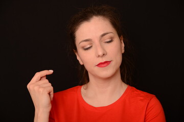 a girl in a red footie 90 shows different emotions. smiling, angry, thoughtful, glad, happy tearing a T-shirt