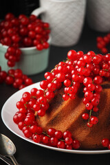 A cake with fresh red currant and tea