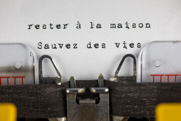 rester à la maison, sauvez des vies (stay at home, save lives) written on an old typewriter