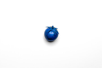 Blue tomato on a white clean background. Fancy products