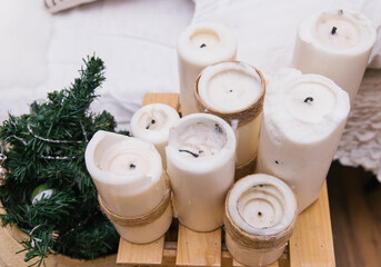 Large thick candles stand as the decor of the room. The burnt wicks of candles.