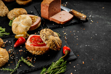 Still life composition of delicious hot dogs and sandwiches with different toppings and dried onion...