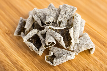 Rice chips with dried seaweed on a wooden table. Dried Beer Snack in Asia