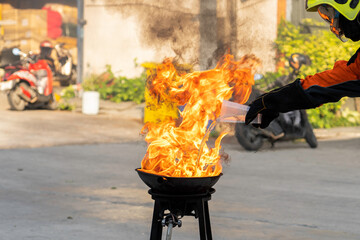 Firefighters teach or demonstrate the fire by pouring water into a very hot oil pan.