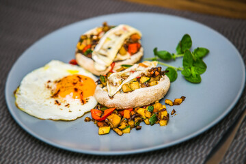 Mushroom stuffed with fresh vegetable mixture and egg. The food in the restaurant. Food styling and restaurant meal serving.