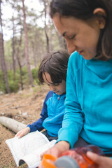 A child and his mother are exploring the forest
