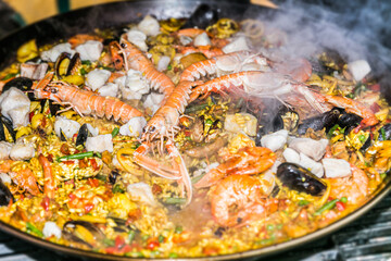 Paella with seafood in a pan. Food styling and restaurant meal serving.