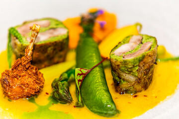 Meat roll with green peas and asparagus. Food styling and restaurant meal serving.