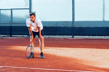 Man tennis player gets tired during his training