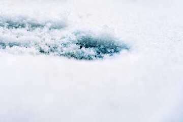Ice on the snowy surface of an icy river, winter background