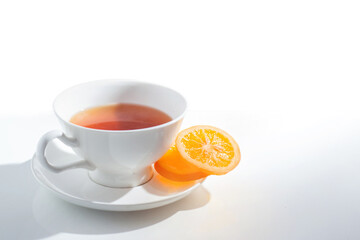 Cup of tea with dried orange slices, isolated on white background