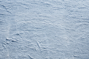 Ice skating rink, cutting ice, snow. Winter sport. Scratches on the surface of the ice. Close-up photo.