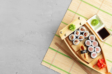 Set of maki sushi on wooden boat tray