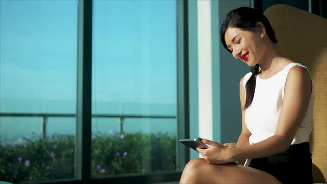 Pretty Mixed Race Business Woman Working At Laptop At Modern Lounge. Concept Of Distant Work And Freelance. Beautiful Successful Lady Using Application On Small Computer And Sitting At Lobby Or Office