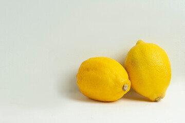 Beautiful close up shot of two of lemon isolated on white background
