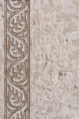 Ornamental print on the granite surface. Vintage ornament on the stone. Embossed drawing. Close-up. Stone texture. Pattern on the stone. Embossed pattern. Wallpaper. Tile. Close-up of seamless texture