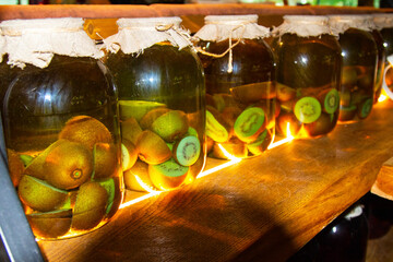 Glass jars with blanks for the winter. Fruit and berry preserves in a dark cellar
