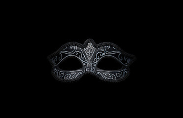 Black Venetian carnival mask on the black background