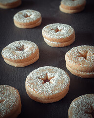 A black tray of sweet and delicious jam filled biscuits