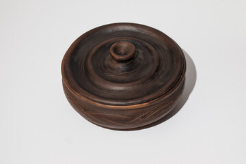 Clay plate with lid on white background