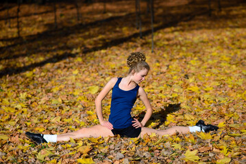 Healthy young woman warming up stretching her arms and looking away in the road outdoor.