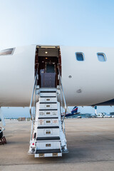 Entering a luxury private jet using the airplane stairs	