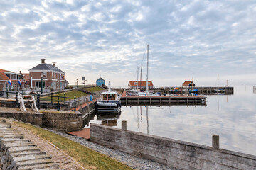 Fototapeta premium Old harbor with sluice and buildings in Hindeloopen, Netherlands