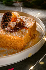 honey cake with honeycombs and christmas decorations and lights. sweet dessert for the holiday, close up