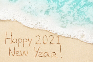 Happy New Year 2021 written on the beach