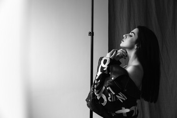 Photoshoot of a young brunette. Girl in jeans. Black and white photo.