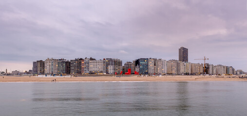 Skyline of Ostend (Belgium) against cloudy sky after sunset.