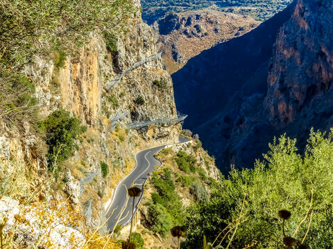 A view over the road that meanders through the Topolia Gorge, Crete on a bright sunny day