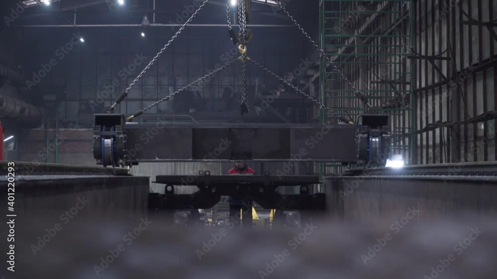Poster wagon platform stands on rails at factory. clip. metal platform of train with wheels was put on rail