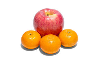 A big red apple and three mandarin oranges or tangerines isolated on white background. Close-up and macro.