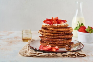 Stack of french toast with cottage cheese, honey and strawberries for breakfast. Selective focus.