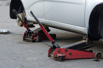 Mechanic screwing or unscrewing changing car wheel by wrench mechanic at work changing a wheel on a car