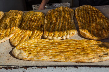 Yellow baked Barbari bread,one of the thickest flat breads,  on the food stall in Shirazi, Iran
